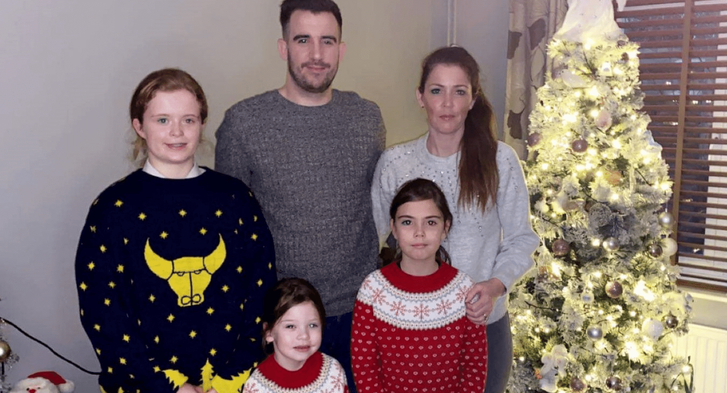 Ella and Family around Christmas tree