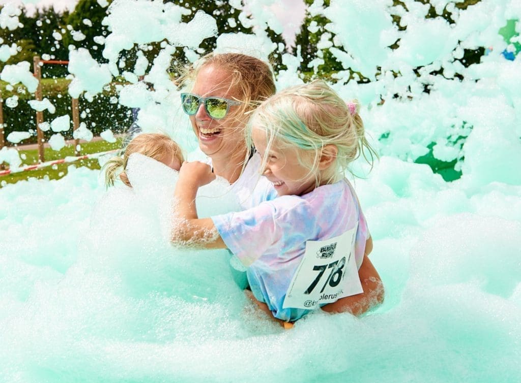 mother-with-children-taking-part-in-bubble-rush