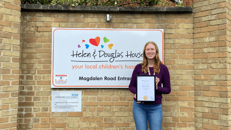 Sophie HR (1) Sophie from HR stood by HDH sign with apprenticeship certificate