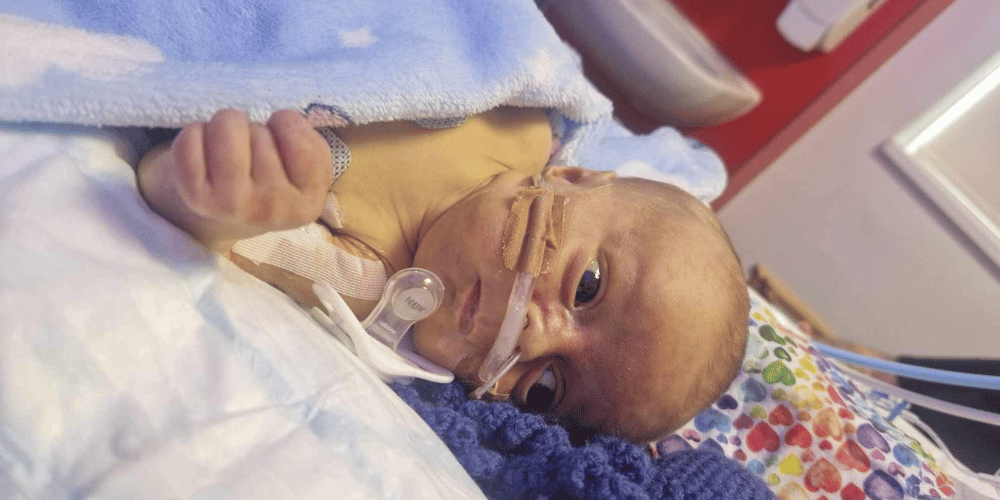 A photo of a baby in hospital.