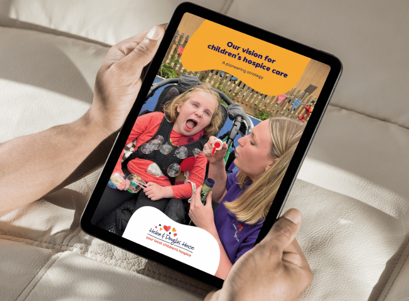 A female nurse standing in a garden.