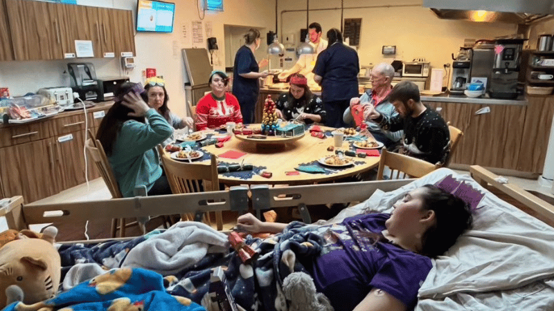 Two photos - on the left a girl smiling next to a sunflower and on the left, a girl smiling holding a dog in a woods.