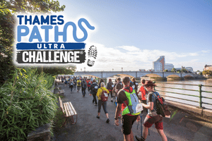 Two women hiking through a sunlit forest