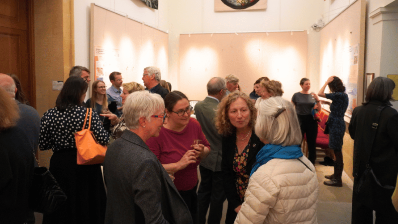 A crowd of people chatting in small groups