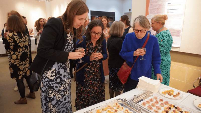 Three women at a table of canapes