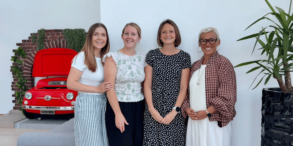 Four women smiling