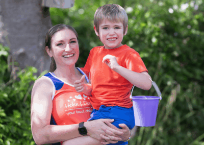 Rory and Mum blog feature image Belle holding her son, Rory, in the Helen & Douglas House garden.