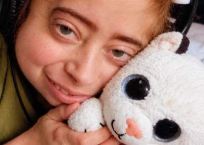 Feature image (7) A young boy cuddling a white toy tiger.